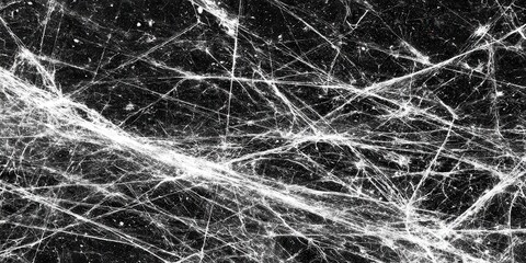 Abstract pattern of intricate white spiderwebs densely covering a dark background