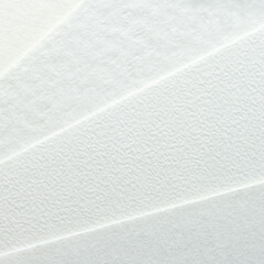 Close-up of textured white paper with subtle patterns.