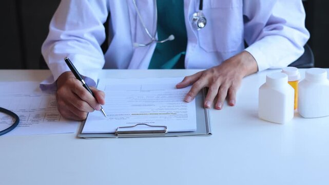 Doctor or authorized medical professional writing the order of specific medication for a patient to treat an illness or injury.