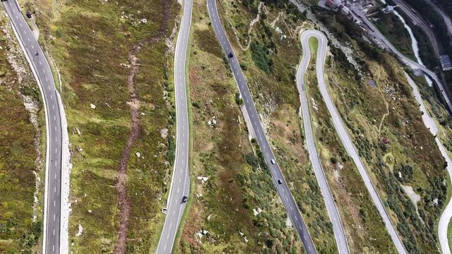 aerial of a mountain road with switchbacks in switzerland