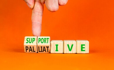 Palliative or supportive therapy symbol. Concept words Palliative to Supportive on beautiful wooden cubes. Beautiful orange background. Medical, palliative or supportive therapy concept. Copy space.