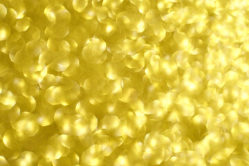 Golden bokeh background with soft light patterns and abstract circular shapes creating a warm, dreamy atmosphere.