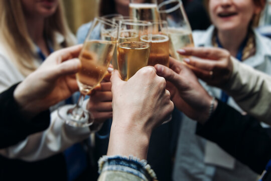 Group of businessmen celebrate acquisition, closing successful merge deal, clinking raise glasses with alcohol, sparkling wine, toasting and cheering, colleagues office team corporate party event