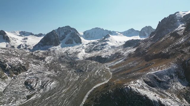 Aerial drone footage of snow-covered moraine of the Bolshoi Ala-Archa glacier, Kyrgyzstan.