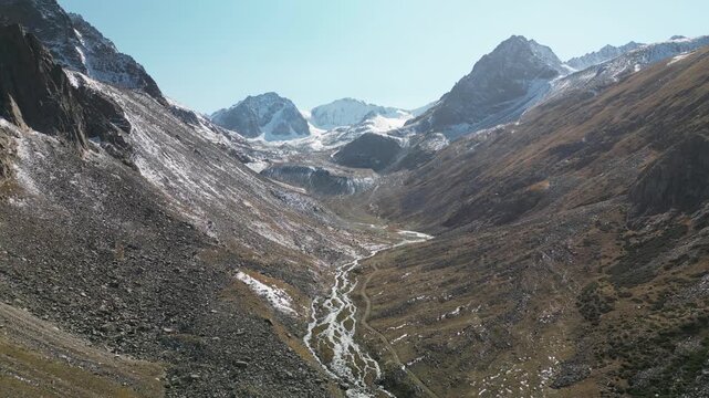 Aerial view of a mountain trail along a river leading to the moraine of the Bolshoi Ala-Archa Glacier. Location -  the end of Ala-Archa Gorge on the slope of the Kyrgyz Range.