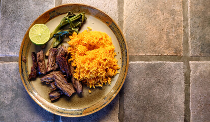 Jollof west african rice, grilled skirt steak and green onions plate 