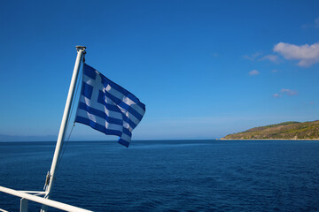 The Greek flag against the backdrop of Greece