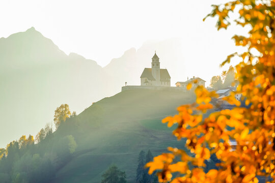Scenic sunset autumn view of the Church in the village of Colle Santa Lucia, Dolomites, Italy, Europe