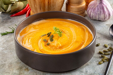 Tasty pumpkin cream soup served seeds