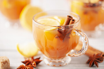 Homemade Wassail Mulled Apple Cider with Lemon and Spices in glasses. Winter alcoholic hot drink.