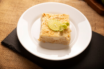 Carlota de Limon, a cold, no-bake dessert made with layers of Maria cookies and a creamy mixture of lemon and condensed milk, an easy homemade recipe very popular in Mexico.