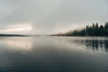 Sunrise over a foggy lake