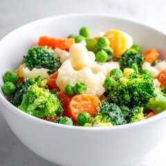 Close-up view of a ceramic bowl filled with colorful mixed vegetables