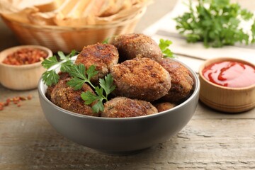 Tasty meat patties served on wooden table, closeup