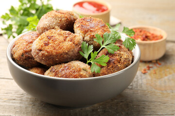 Tasty meat patties served on wooden table, closeup