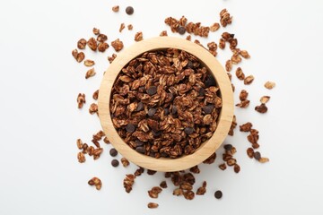 Delicious granola with chocolate chips in bowl on white background, top view