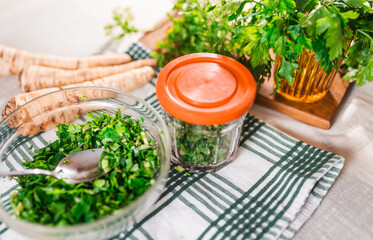 Preparing fresh parsley leaves to freezing for winter.