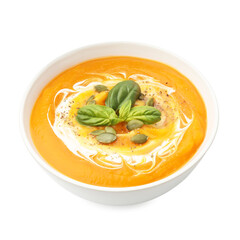 Delicious pumpkin cream soup with basil and seeds isolated on white
