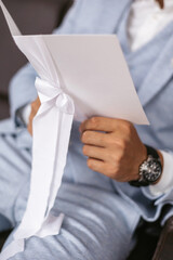 A close-up of a man in a jacket reading a brochure