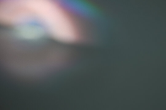 Soft focus gray grain blur texture wall with prism refraction. Light and shadow smoke abstract gradient reflection rays background.