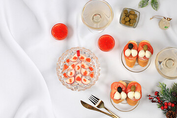 Christmas and New Year's dishes, bruschetta caprese with mozzarella cheese, tomatoes and olives, radish and red caviar salad, champagne, table setting and menu ideas, healthy lifestyle concepts