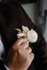 A close-up of a man adjusting his jacket