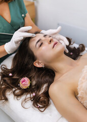 young woman in beauty salon face massage