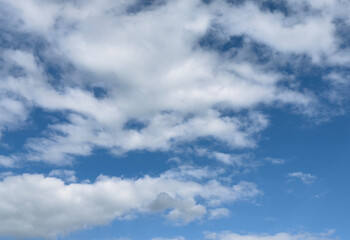 Blue sky with scattered cumulus clouds