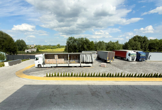 Logistics yard with open curtain side trailer