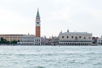 Venice, Italy - June 23, 2025: Iconic view of Venice's St. Mark's Campanile and Doge's Palace from the water, showcasing historic architecture and vibrant city life with copy space