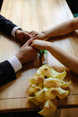 Close-up of the bride holding the groom's arm