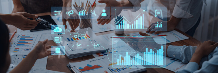 Teams engage in a dynamic business meeting, utilizing data visualization tools and analytics to drive discussion and enhance strategic decision-making in a modern office environment. Trope