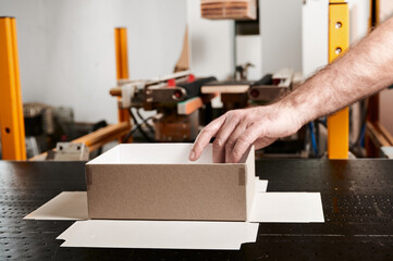 Crafting unique cardboard boxes in a bustling decorative packaging factory with skilled hands and advanced machinery
