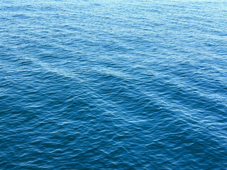Blue ripples water surface background.