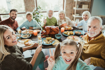 Family feast today smiles abound as generations share turkey and laughter around a warm holiday table