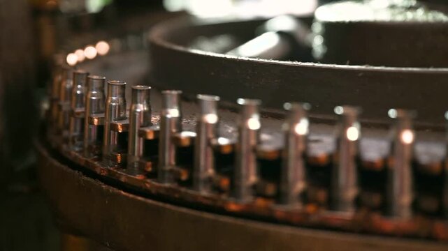 Metal cartridge cases transported by conveyor at plant