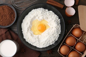 Ingredients for dough on wooden table, flat lay