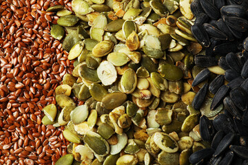Different raw seeds as background, top view