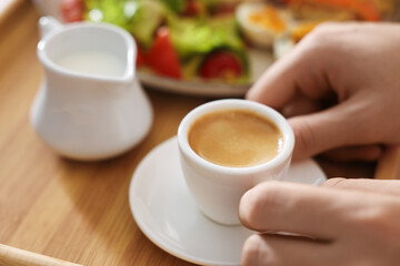 Man having breakfast in bed, closeup. Hotel room service