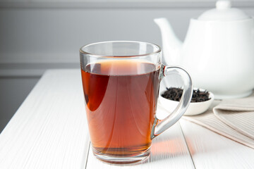 Delicious tea and brew served on white table, closeup