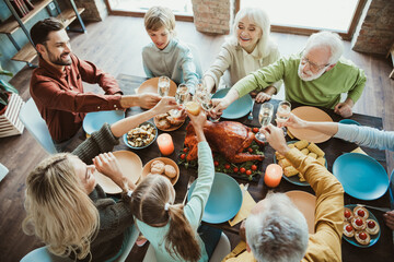 Funny wholesome family thanksgiving feast where generations gather to celebrate togetherness around a roasted turkey at a cozy home table with friends