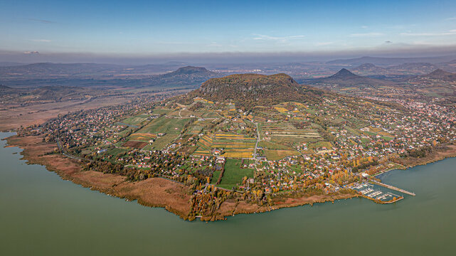 Autumn aerial view of Badacsony and Lake Balaton
Aerial photograph of Badacsony Hill and the surrounding vineyards in autumn colors by Lake Balaton, Hungary. Peaceful rur
