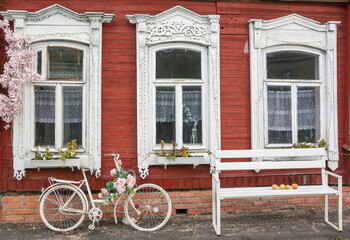 The facade of a wooden farmhouse with carved windows