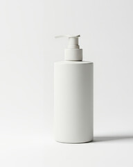 Minimalist white plastic pump dispenser bottle for cosmetic products isolated on a bright high-key setting.