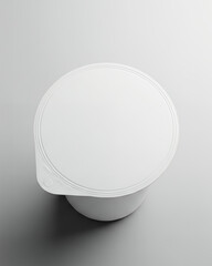 Overhead view of a blank white plastic container with a foil seal lid for product mockup presentation