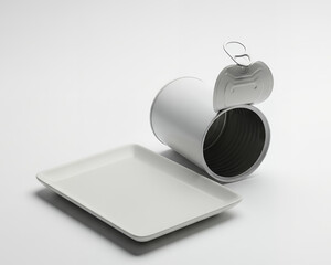 Minimalist still life of an open silver can and a rectangular white plate in a studio setup