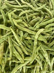 A closeup photo of a bunch of organic green beans filling the frame.