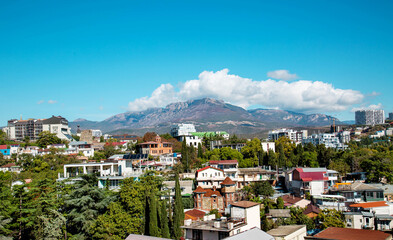 Obraz premium View of the village of Alushta with mountain hills on a clear sunny day. Landscape, sights of Russia, sea, mountains.