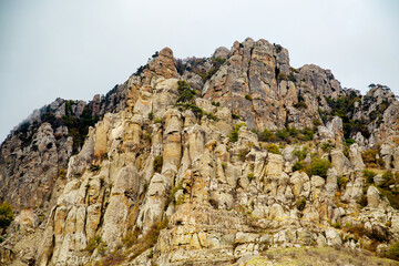 The cliffs of Ghost Valley with mountain hills, boulders on a clear sunny day. Landscape, sights of Russia, sea, mountains.