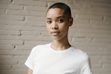 Young woman poses confidently in a minimalist room with a beige wall